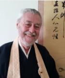 Image of James Myo'un Ford Roshi dressed in robes and smiling
